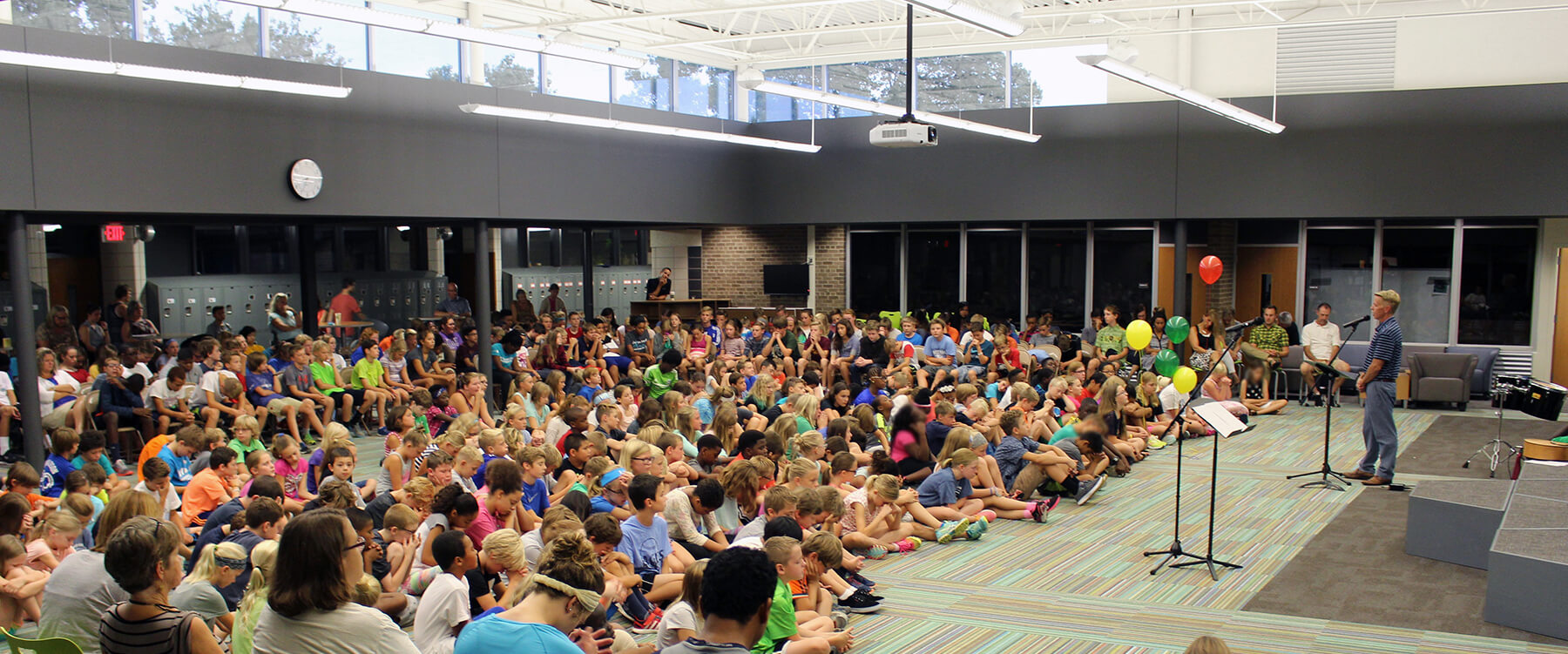 Grand Rapids Christian Middle School kids gathered sitting in a large multipurpose room