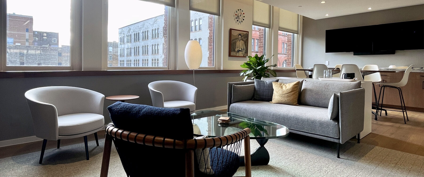 interior of the Victory room in a soft seating area with windows looking out to downtown