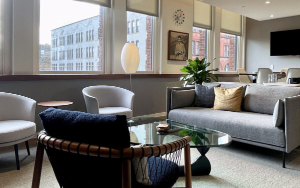 interior of Victory in a soft seating area with windows looking out to downtown