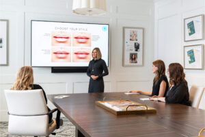 Woman giving a presentation on lip filler to three women seated at a conference table at Bengtson Center for Aesthetics and Plastic Surgeryy