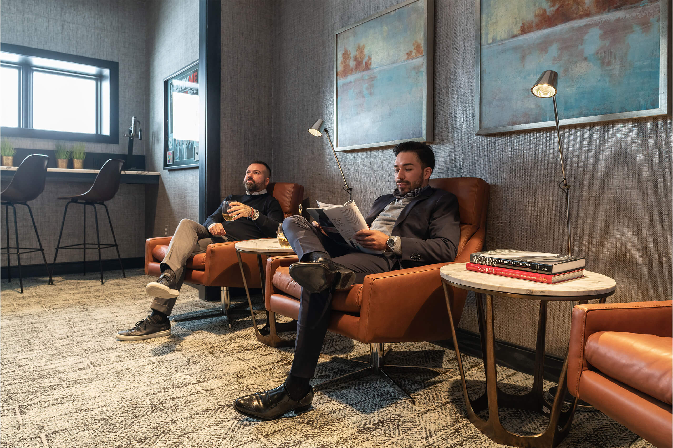 Two men sitting in leather chairs in the waiting area at Bengtson Center for Aesthetics and Plastic Surgery