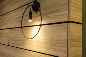 Modern sconce on a wood slat wall