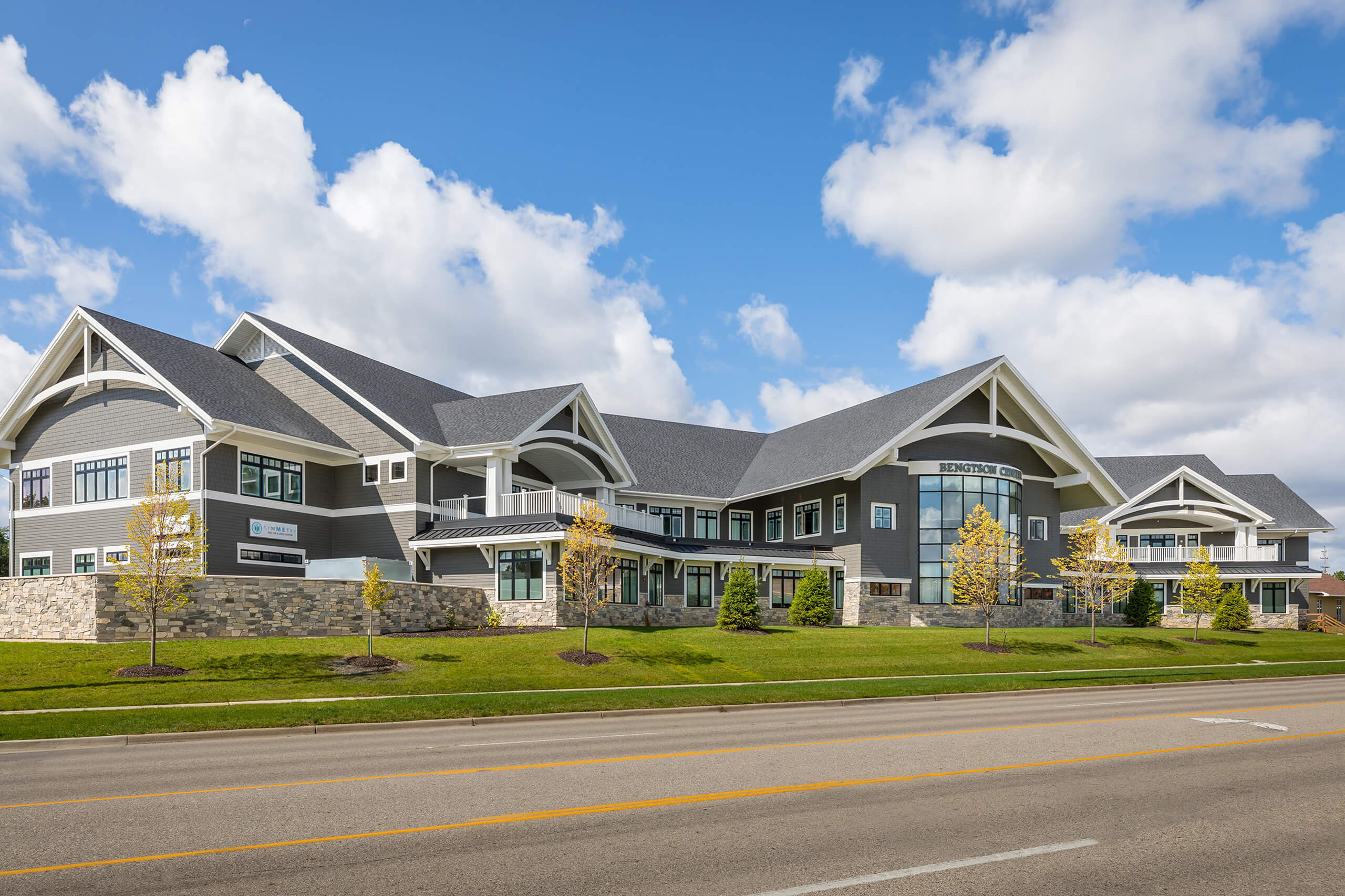 An outdoor view of a large two-story commercial building that's gray with white trim