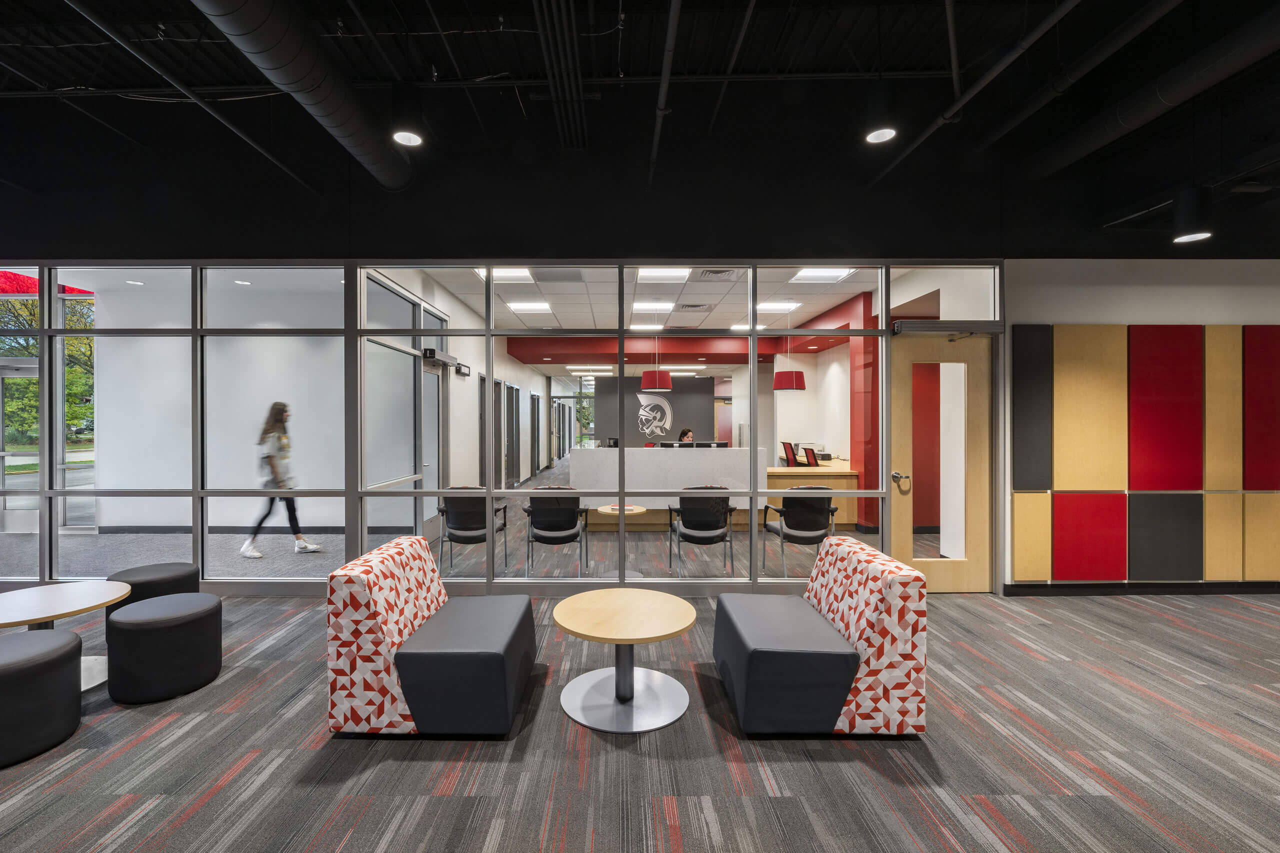 View from a lounge area looking into the reception area through a wall of windows