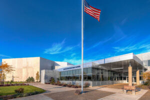 Exterior view of South Christian High School featuring the flag pole