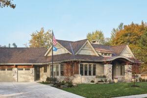 residential family home exterior view of the front door and garage area and flagpole