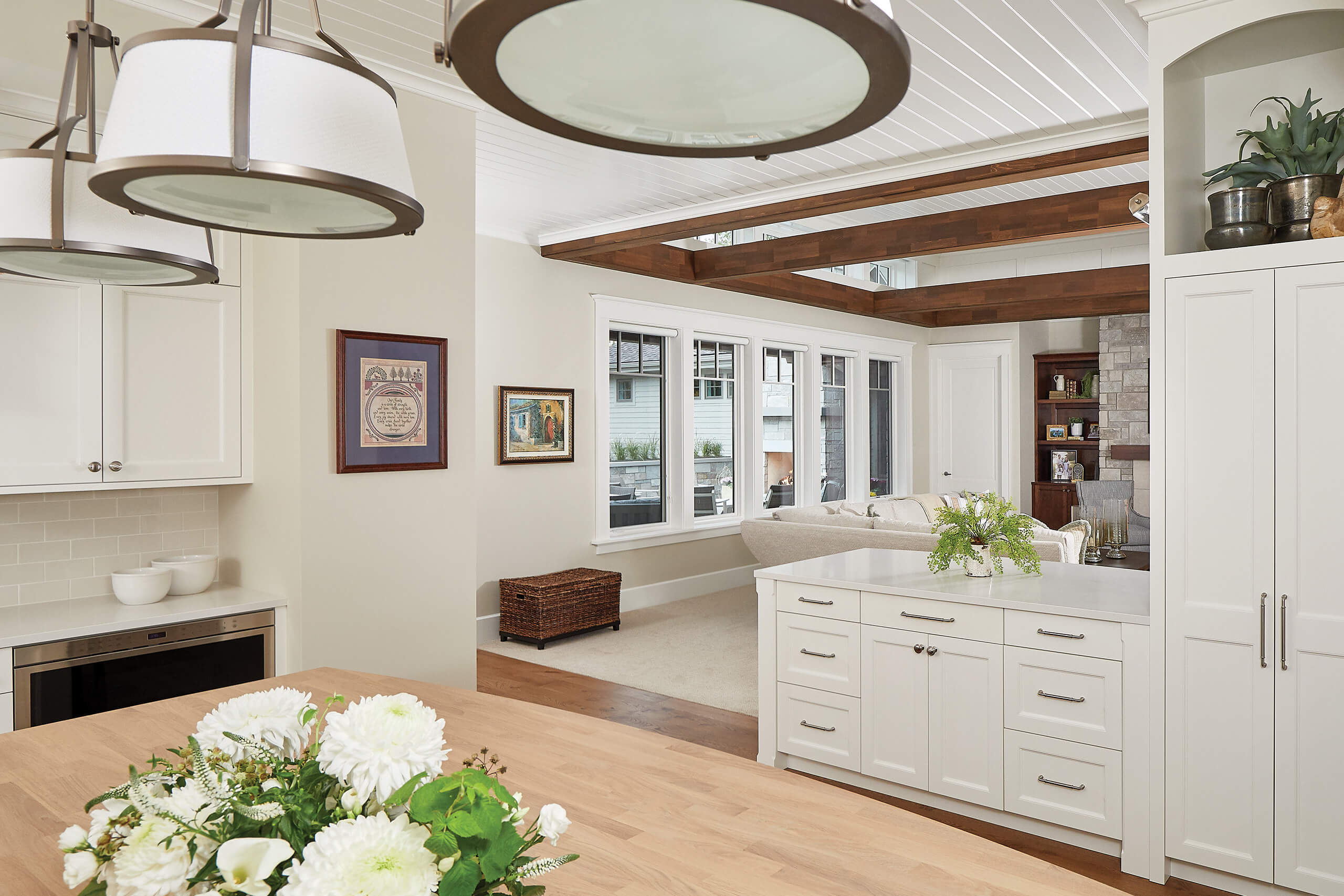 residential home interior with kitchen lights, cabinets facing the seating area of the living room