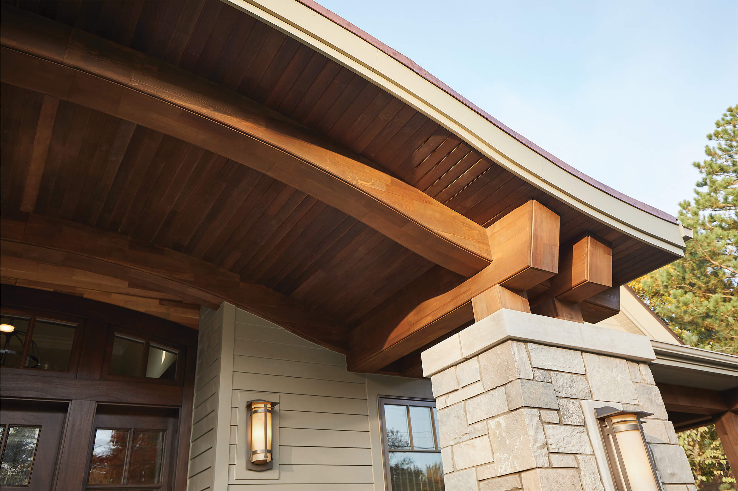 residential family home exteror view zoomed in on details of the entryway porch ceiling made with wood