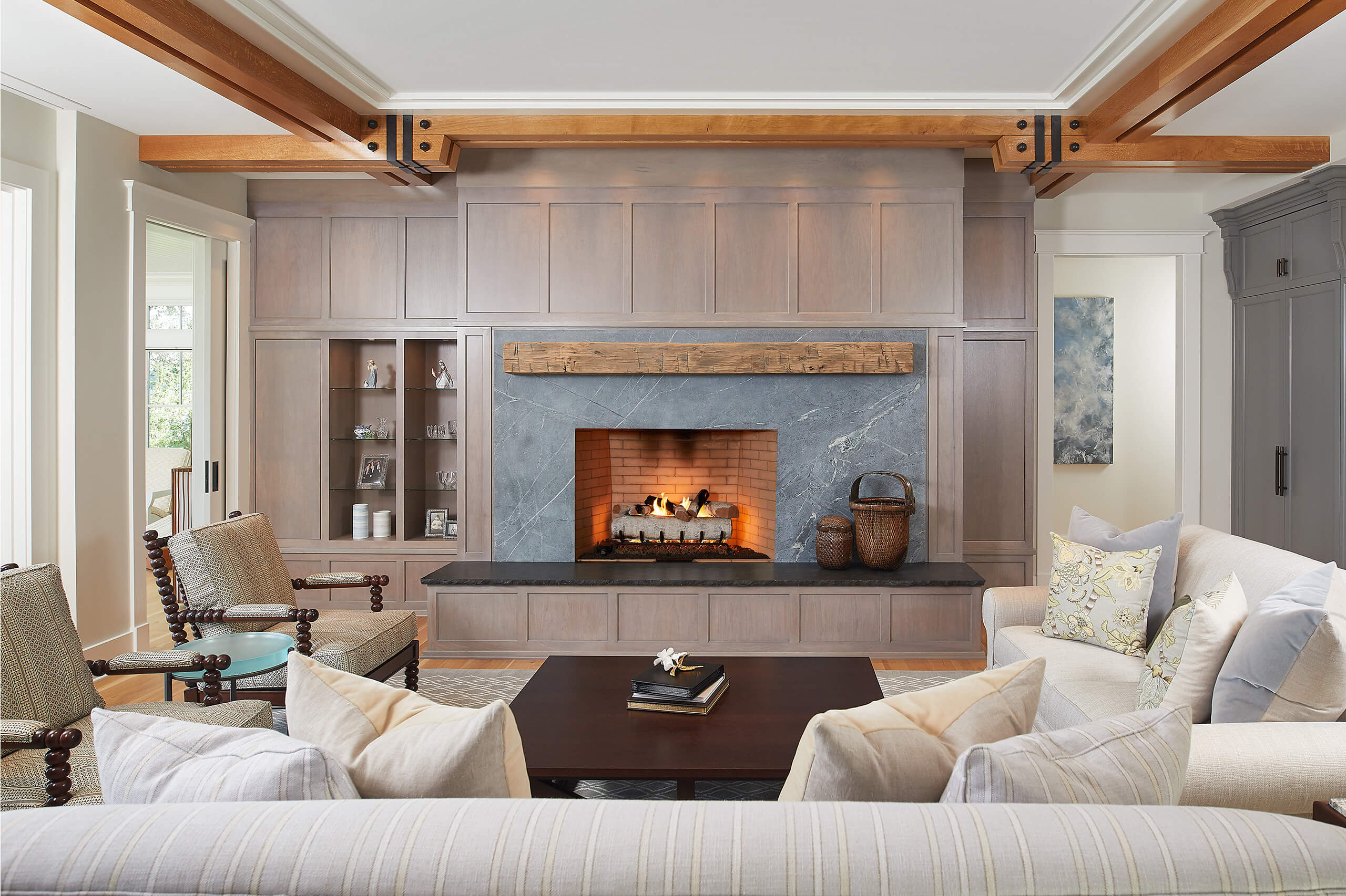 interior view of a fireplace, couches and seating inside a residential lakefront cottage