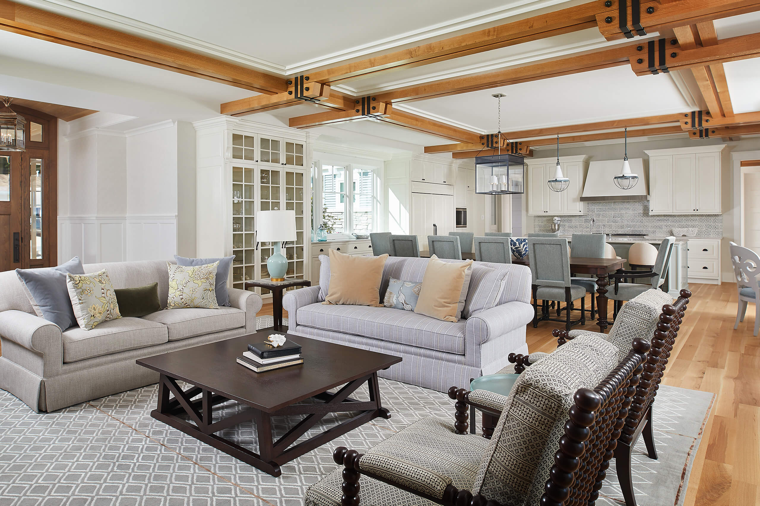 interior view of couches, dining table facing the open kitchen inside a residential home