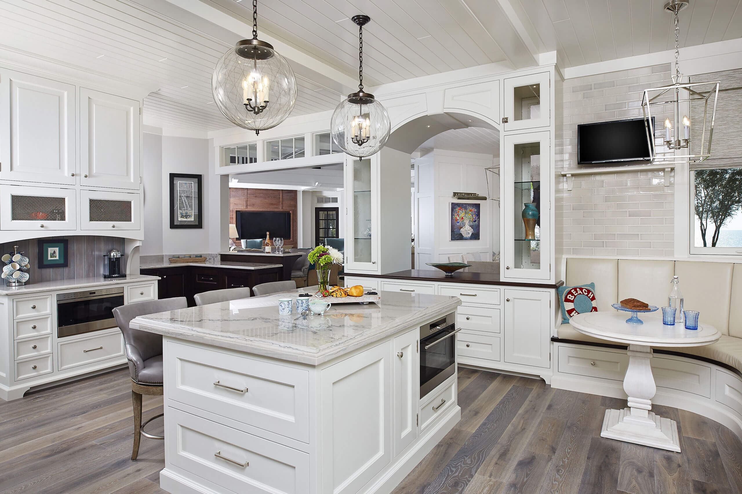 interior view of a residential home inside the kitchen with countertops and seating areas