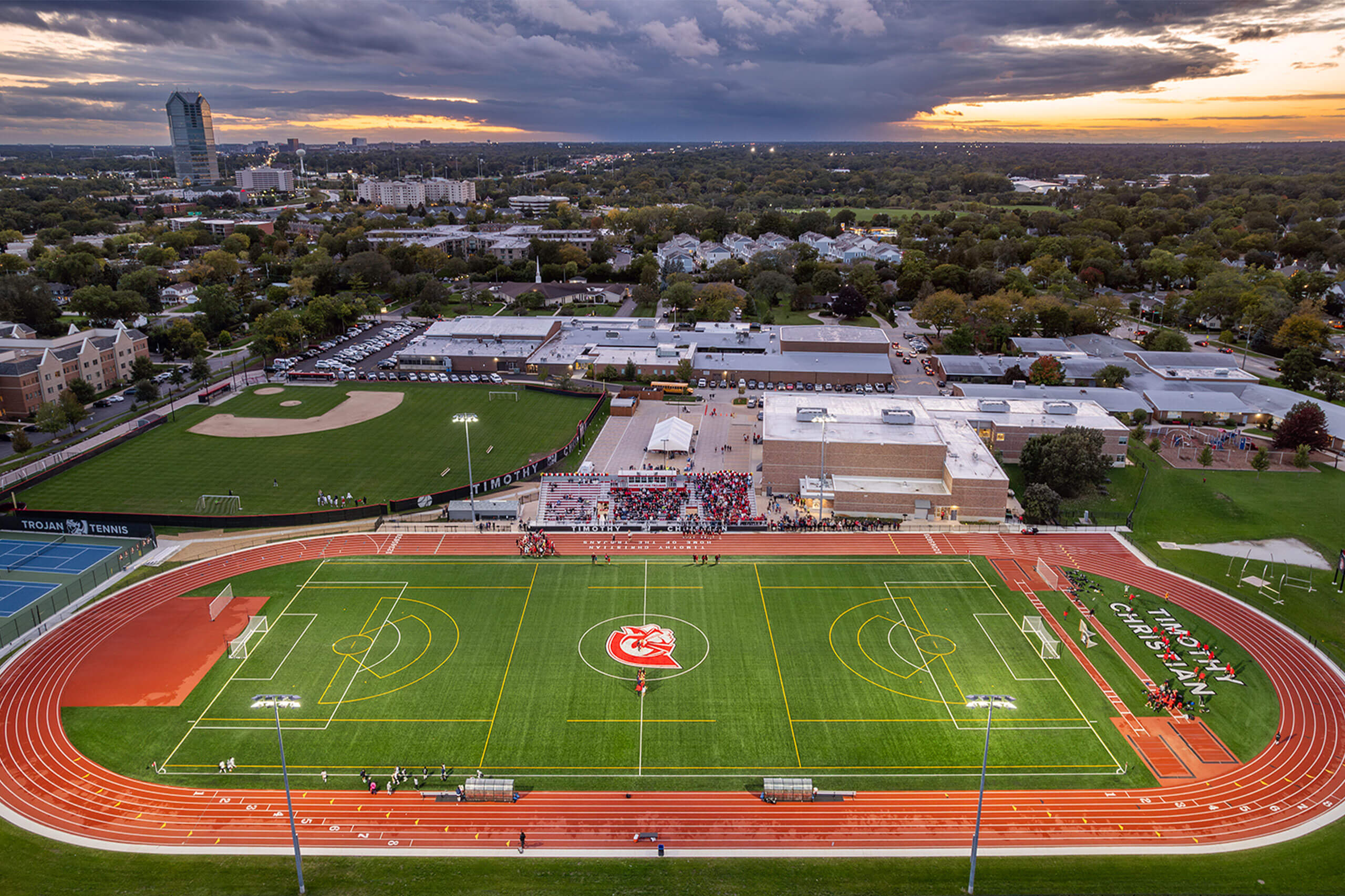 Aerial view of Trojan Stadium with athletes on the field and spectators in the stands