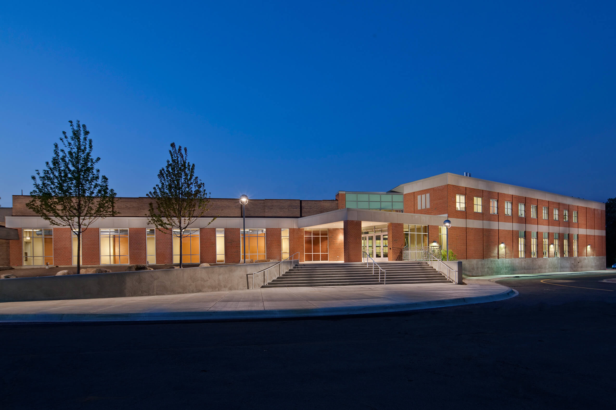 Exterior view of the Trinity College Athletic and Recreation Center, featuring stairs to the entrance, large windows and brick facade