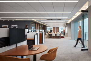 rendering of modern interior of a workplace featuring seating areas and glass windows and doors