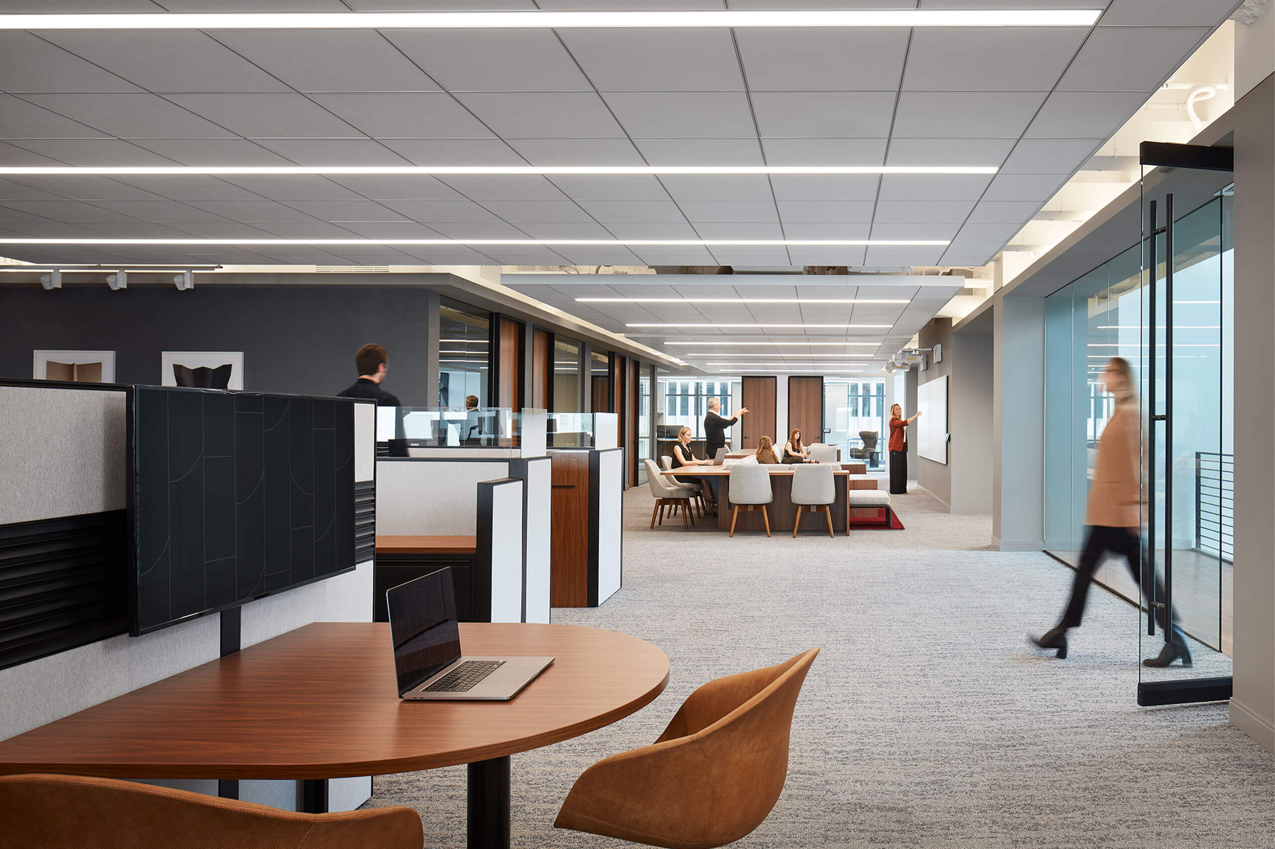 rendering of modern interior of a workplace featuring seating areas and glass windows and doors