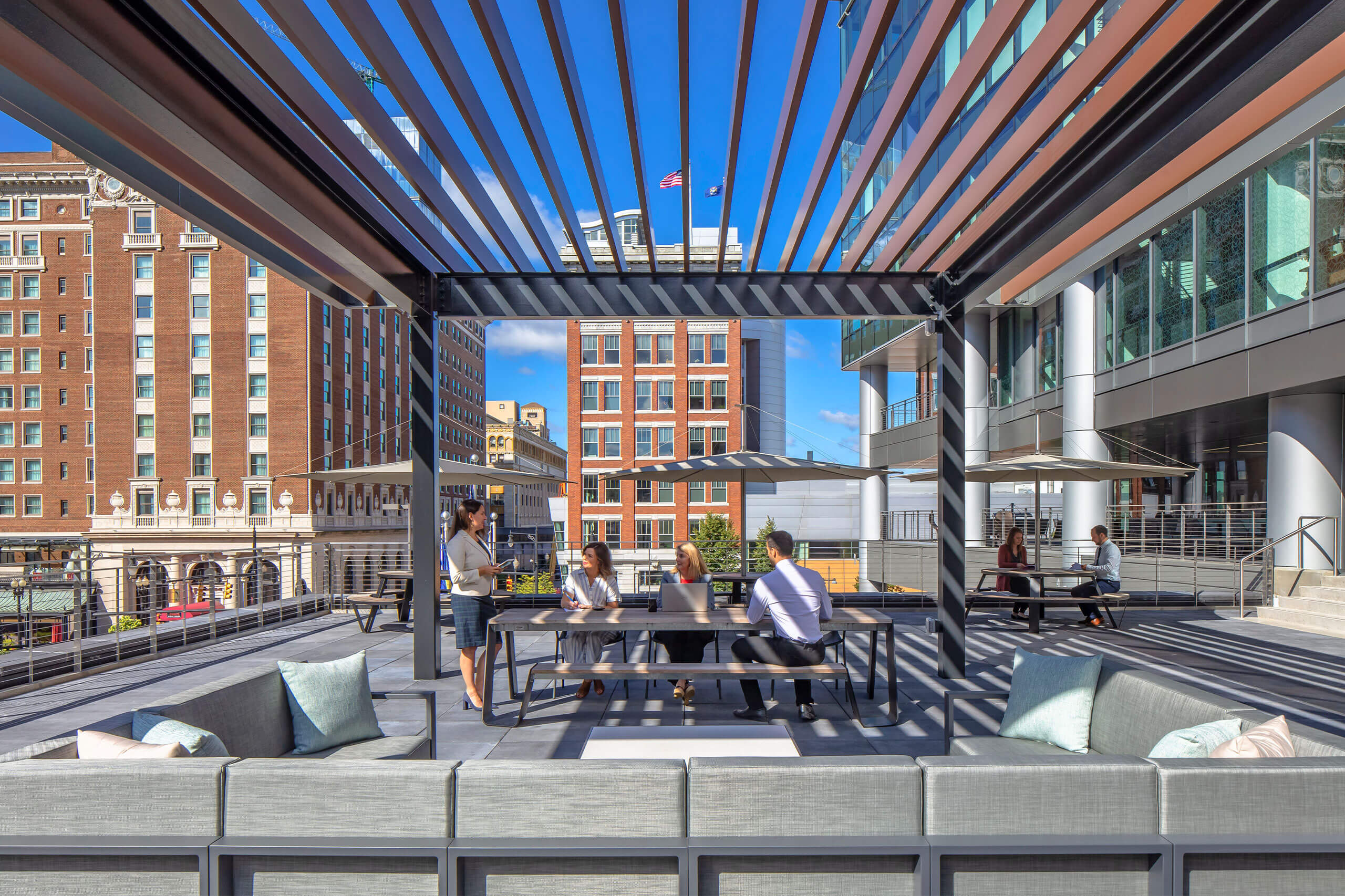 exterior city view showcasing a modern outdoor seating area with tables and umbrellas downtown Grand Rapids