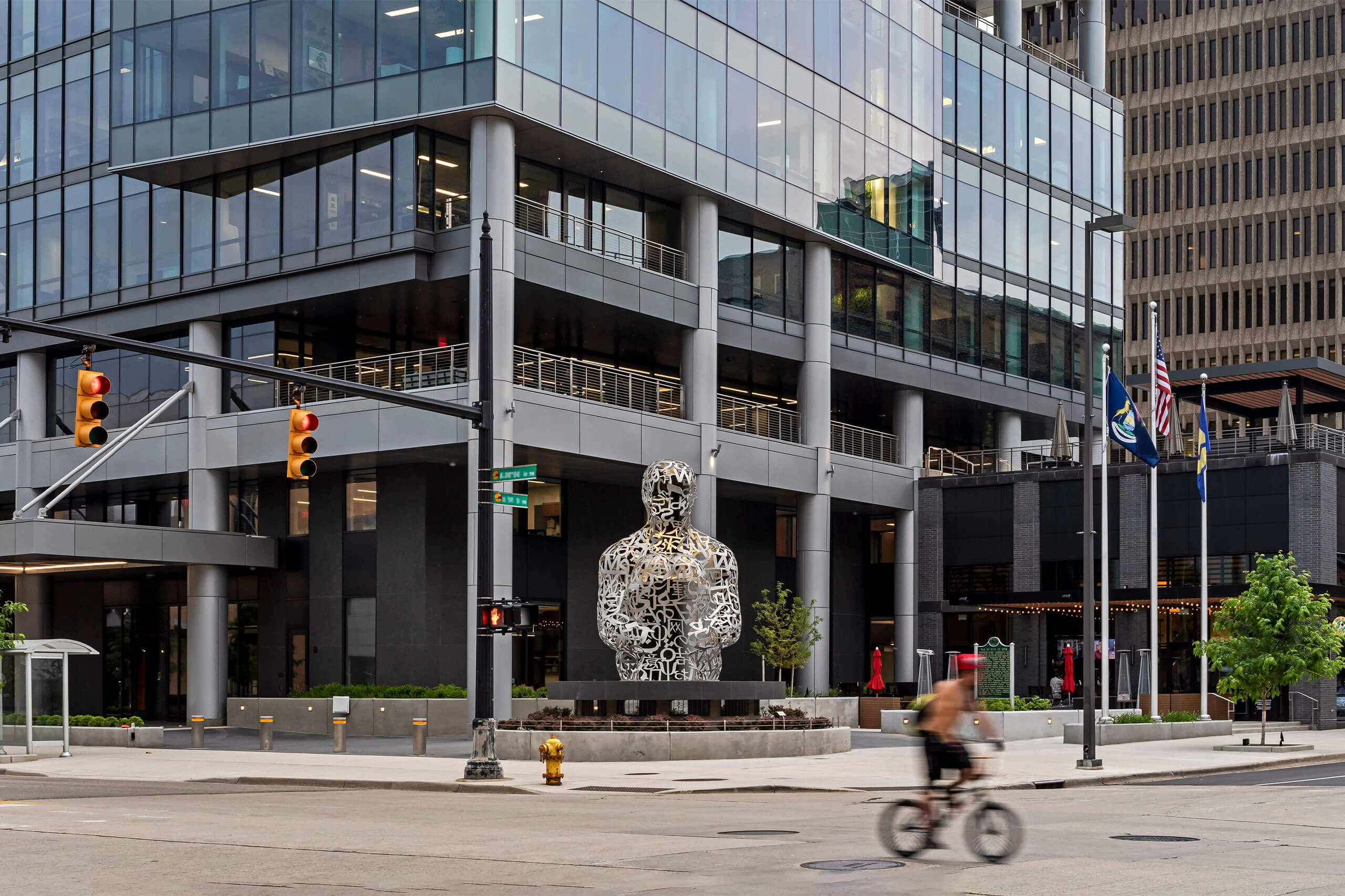 exterior city view showcasing a modern glass office building downtown Grand Rapids at street view