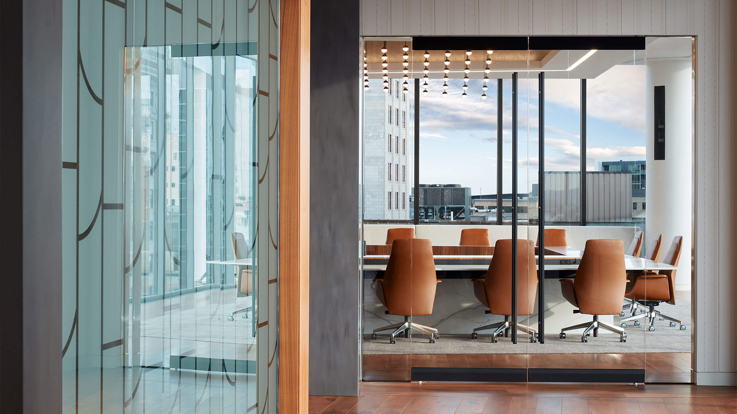 conference room with a table and chairs surrounded by floor-to-ceiling glass walls