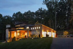 exterior view of a modern residential home lit up from within at dusk