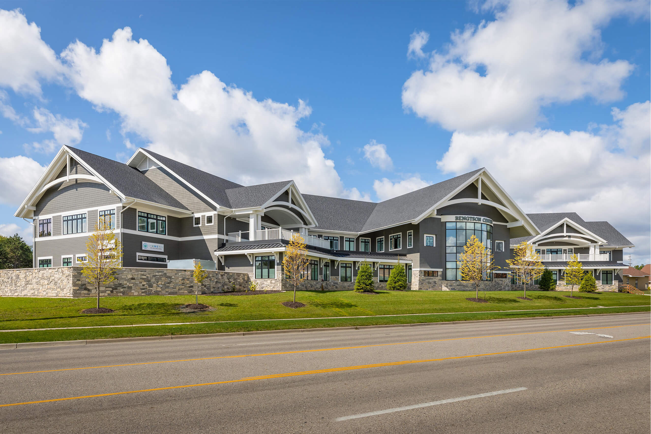 An outdoor view of a large two-story commercial building that's gray with white trim