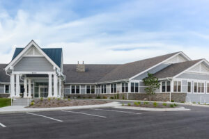 Entrance of a commercial healthcare building and view of the parking lot