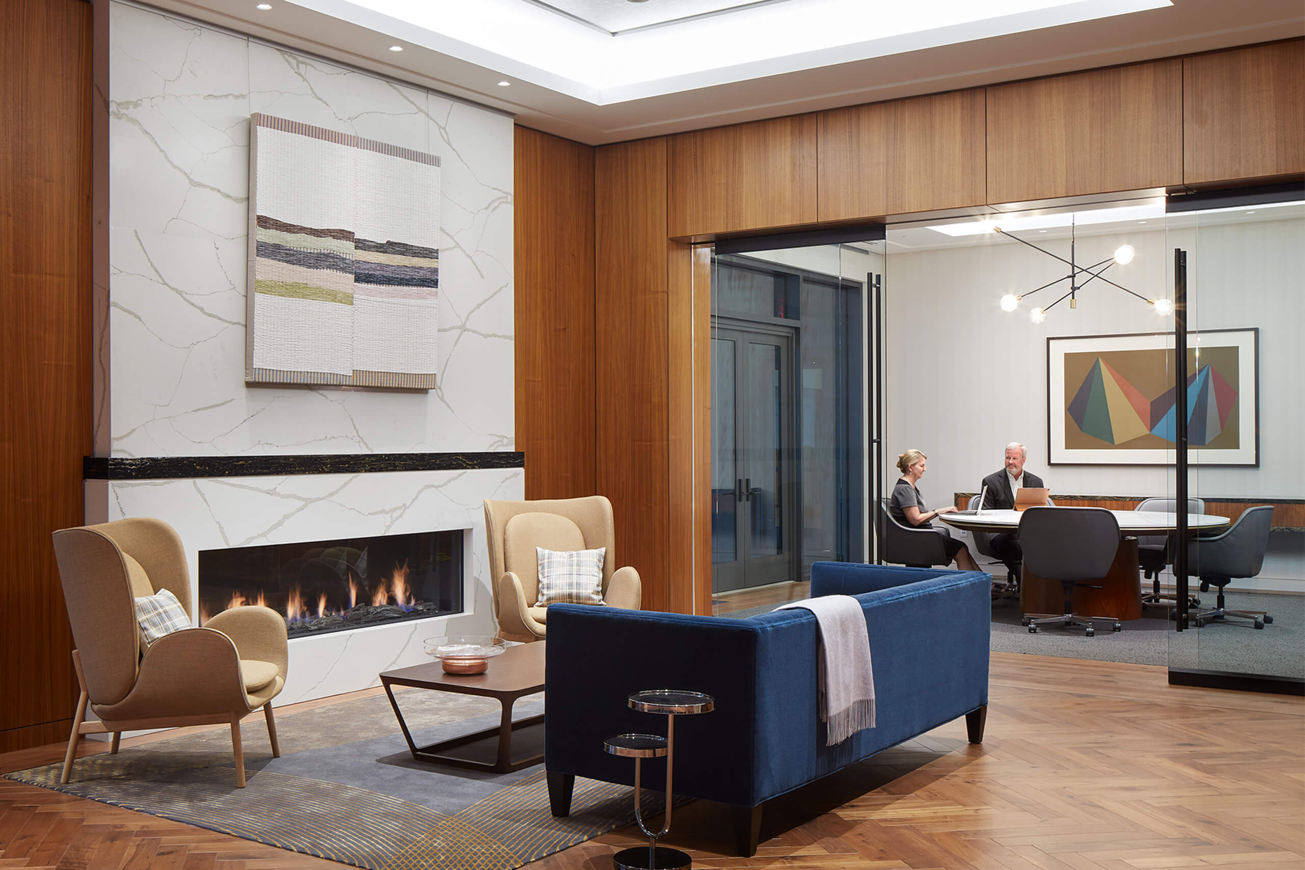 conference room separated from a sitting area with fire place by sliding glass doors