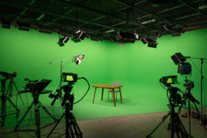 St. Paul Center for Biblical Theology green room with wooden table and chair, surrounded by cameras.