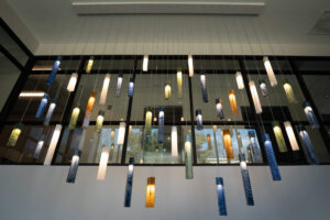 St. Paul Center for Biblical Theology interior photo of hanging glass lights of various lengths and colors.