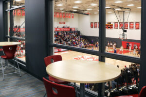 Inside of Timothy Christian Middle School athletic facility, looking through a window onto the basketball court.