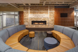 Grand Rapids Christian High School interior room with a fireplace and a half circle of leather and cloth seating area