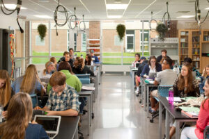 Grand Rapids Christian High School interior of a classroom with students four to a table with books and papers