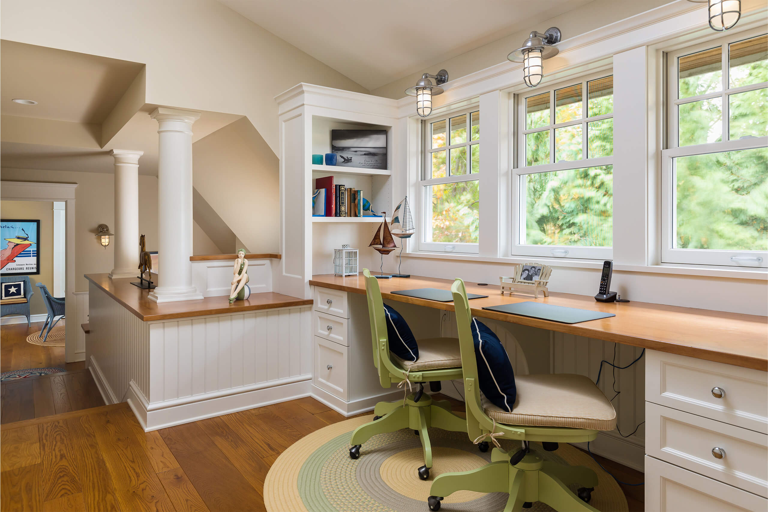 Interior of a shingle-style cottage with a desk and bookshelf setup