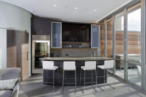 urban loft interior looking at the kitchen area with barstools at a breakfast bar