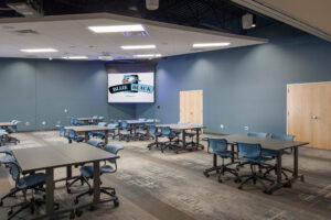 multipurpose room with blue walls and projection screen