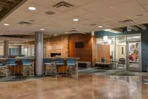 common space outside of classroom with stone fireplace and tiered seating