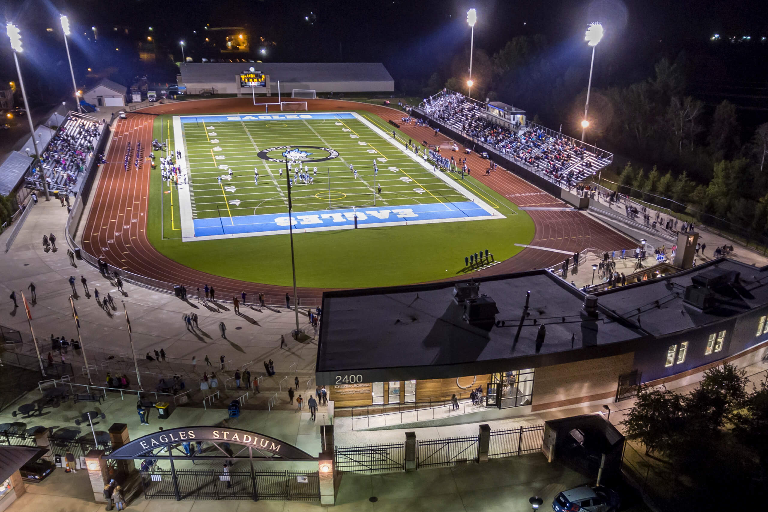 aerial of football stadium and gate entrance at nighttime