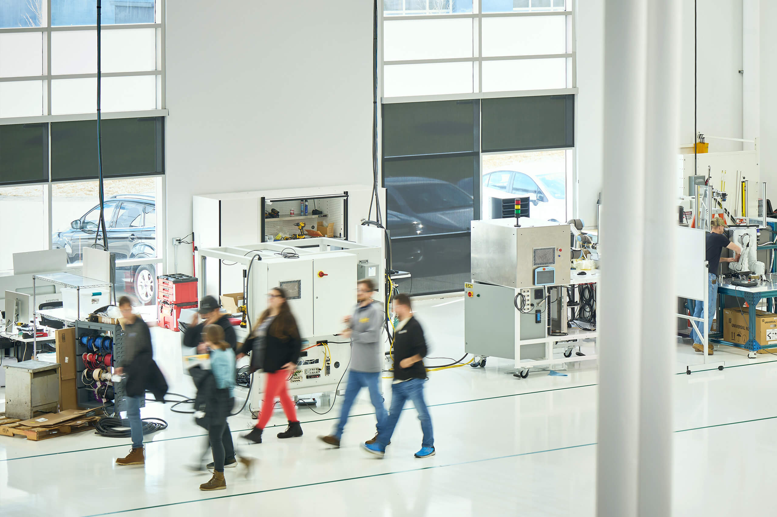 Autocam Medical interior, people walking in plant