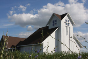 Good Shepherd Lutheran Church exterior cross with flowers