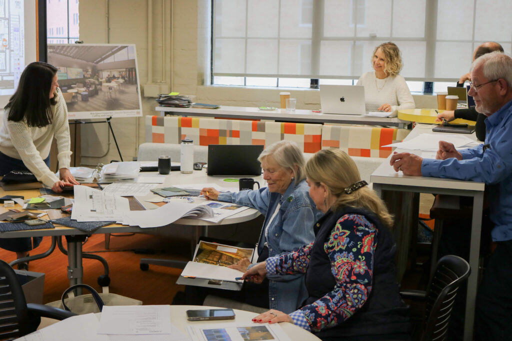 a group of people collaborating and reviewing interior samples