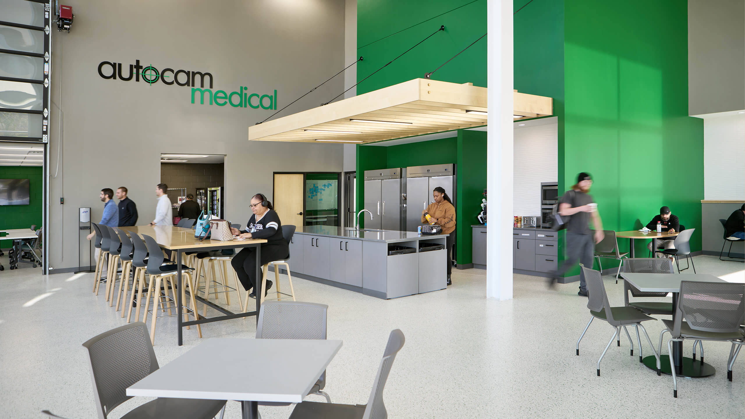 company breakroom with kitchenette and overhead door to an adjacent meeting room