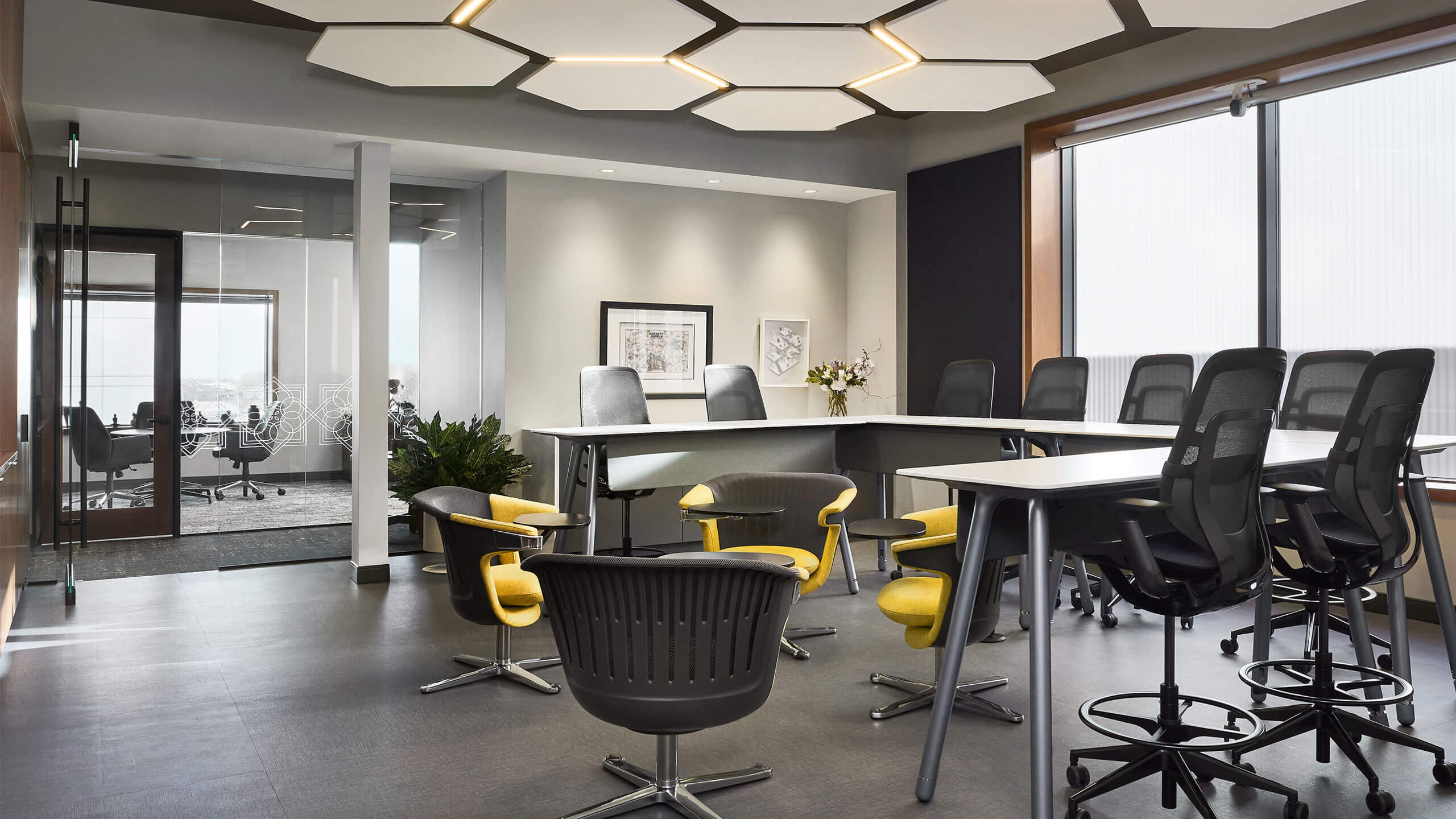 a collaborative workspace with decorative acoustic ceiling tiles