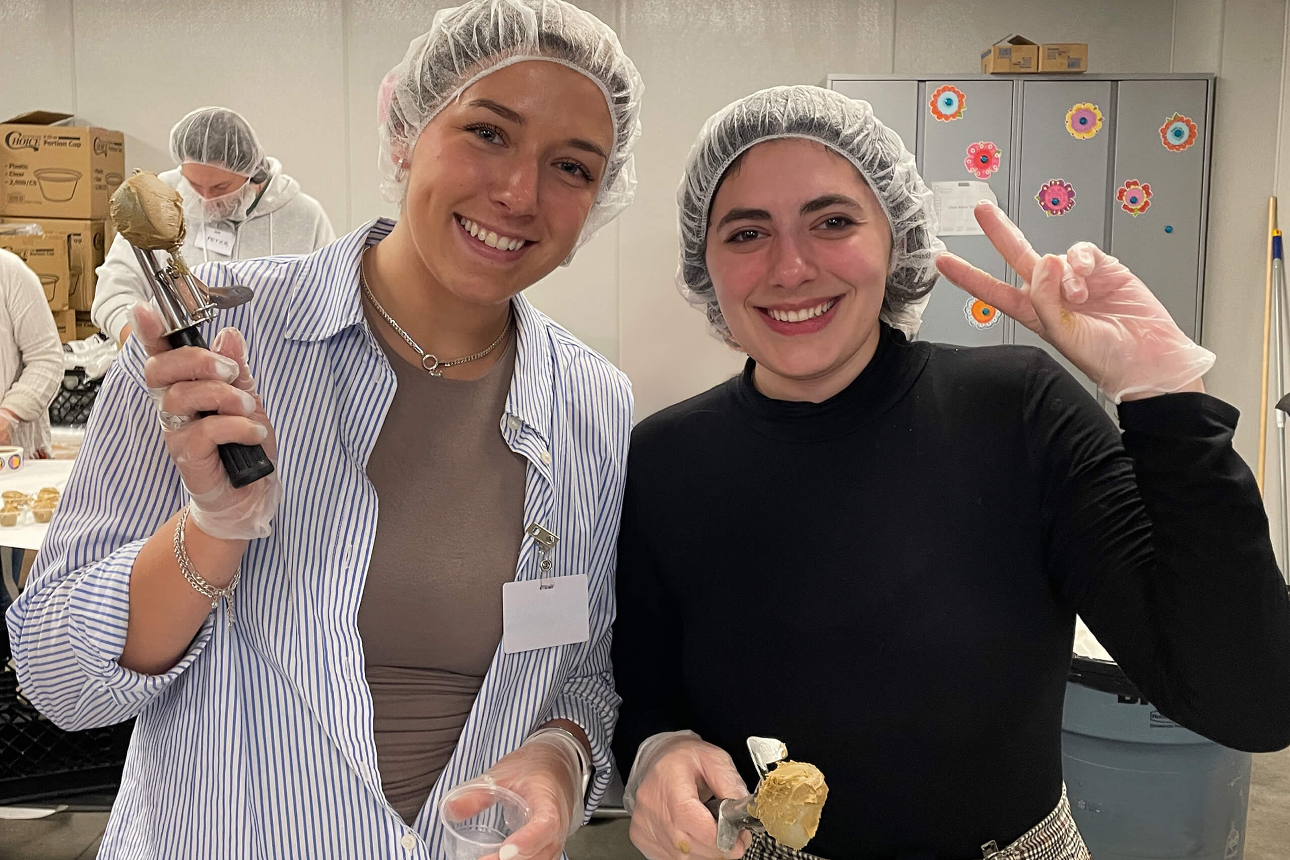 two volunteers in hair nets