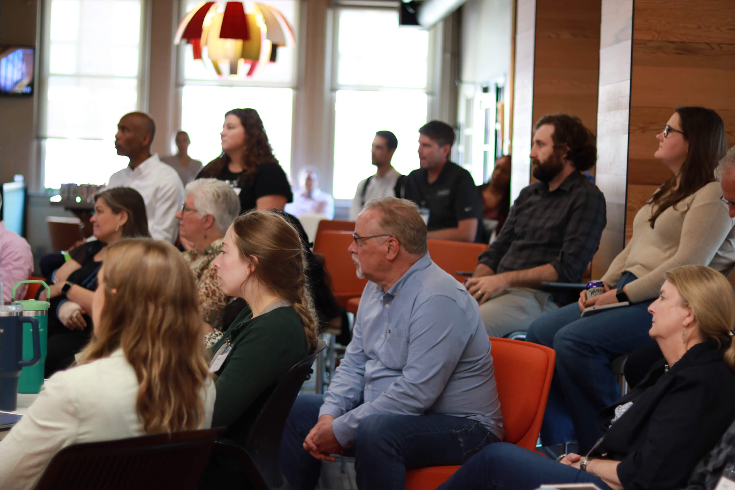 a group of people intently listening to a speaker