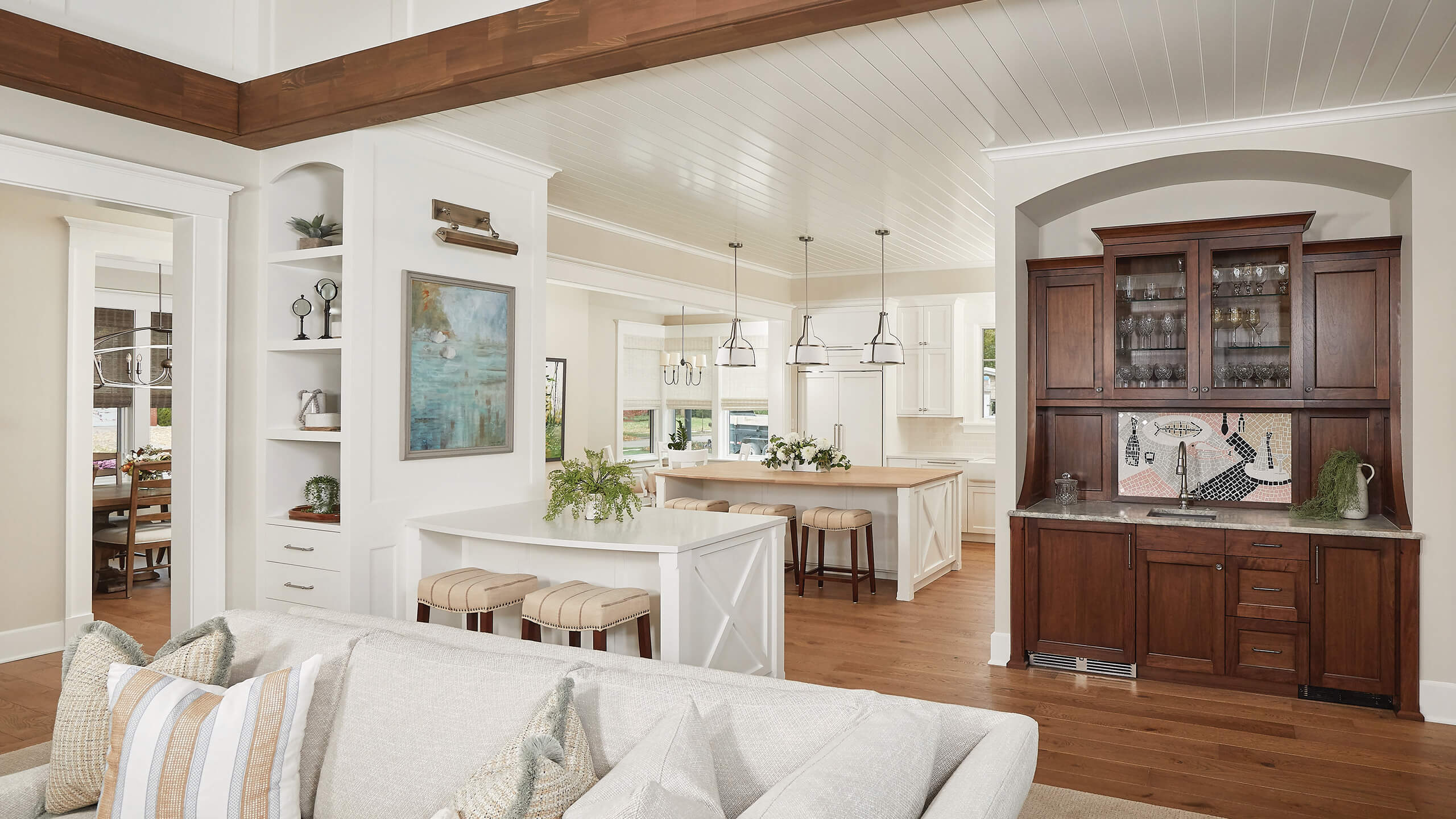 interior view of a home showing dining and kitchen areas from a sitting room