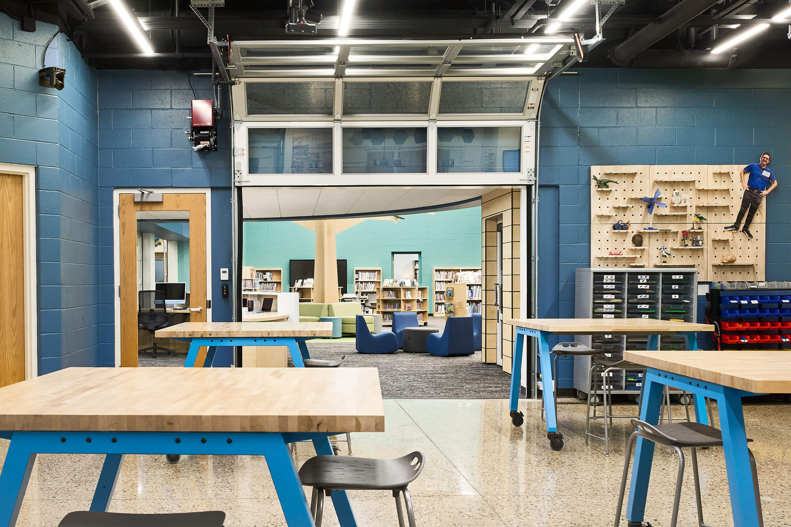 view into library space through overhead door in Ada Christian School maker space