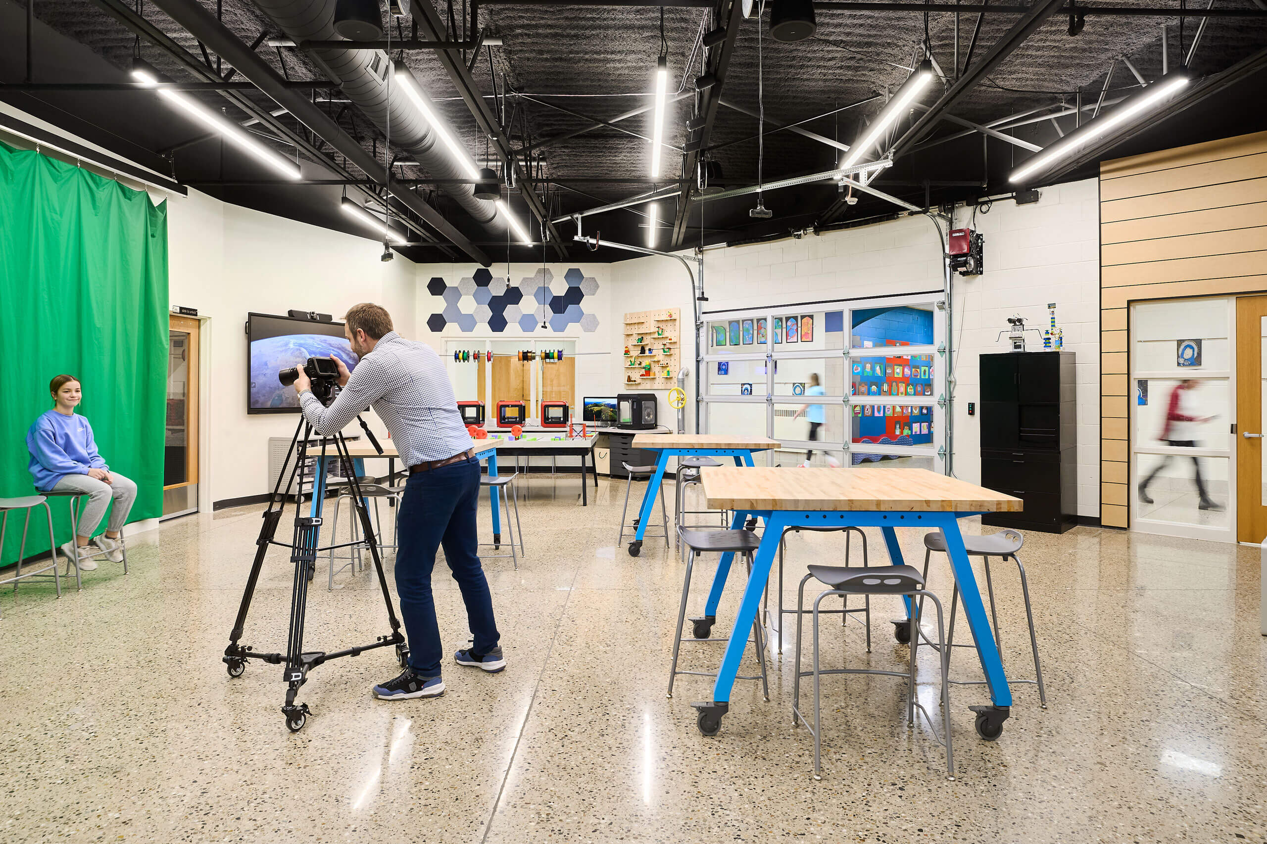 student being photographed in front of green screen in Ada Christian School maker space