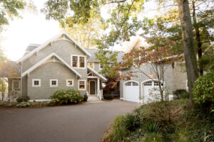 driveway entrance to a cottage placed in a wooded area