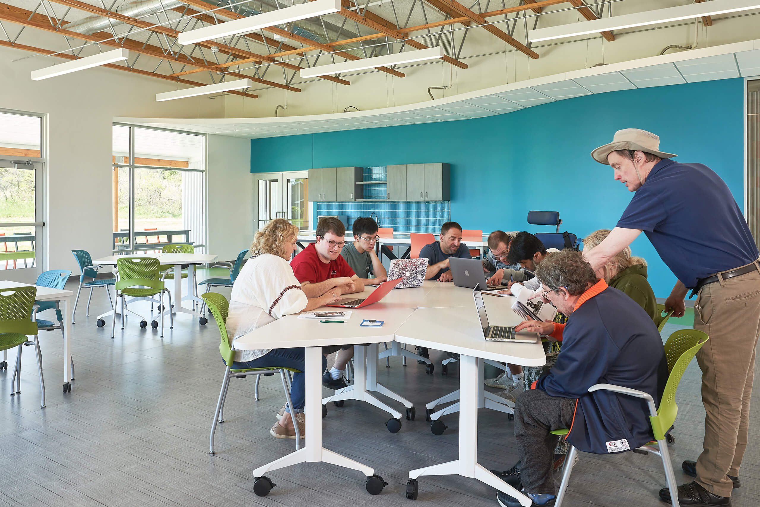 group of people with various abilities gathered together with computers