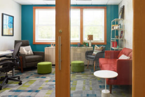 private office with various style soft seating and a work desk