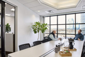 conference room with two men meeting at one end of the room